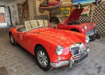 MG MGA Triumpf TR3a rouge dans l’entrée du garage Autorosati